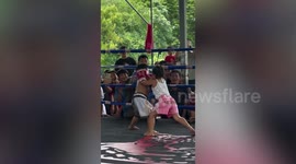Young children fight in a Muay Thai boxing match