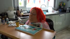 Woman paralysed when she fell learning to walk as baby paints art with mouth