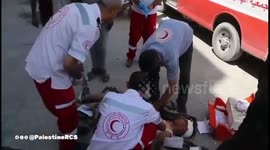 Gaza Strip: Red Crescent ambulance teams retrieve a martyr and an injured person from the east of Jabalia