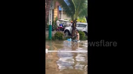 China: People move through the flooded streets of Xishuangbanna