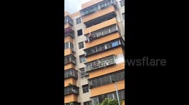 Heroic man lowers down building to rescue child trapped in security net in China