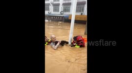 Firefighters rescue elderly man trapped in flash floods caused by rainstorm in China