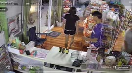 Motorcycle rider crashes through glass shop front