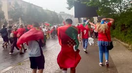Portugal fans endure srong winds, heavy rain en route to stadium for match against Czechia