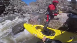 Dramatic rescue of kayaker pinned between log and rocks in Colorado rapids
