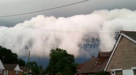 Bizarre storm clouds flow over English village
