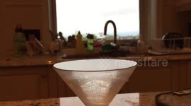 Slow motion olive drop in martini