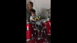 One-year-old girl plays the drums for the first time