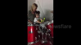 One-year-old girl plays the drums for the first time