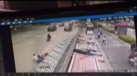 Advertising board blows over and nearly crushes four people