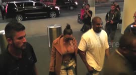 Kim Kardashian and Kanye West get mobbed by the paparazzi at LAX Airport