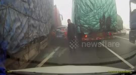 Driver gets out of car to smoke on motorway and narrowly avoids being crushed by lorry