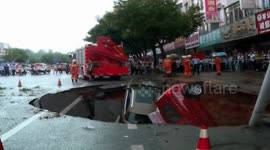Sinkhole 'swallows' four cars in China