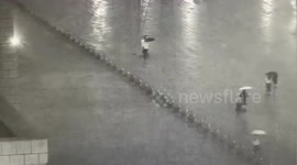 Two pedestrians struck by lightning outside train station entrance