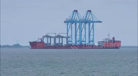 Ship carrying four cranes arrives on the Thames off Kent, UK