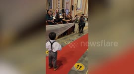 Frustrated little ring bearer stops and tosses ring pillow