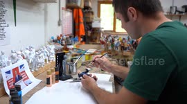 Artist paints miniature figure of Nigel Farage ahead of UK general election