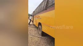 A School bus stuck on a railway line crossing , Train driver emergency break press in time on Northern India