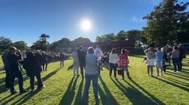People who are amazed and enjoying a view of the sun in the late evening in Scotland