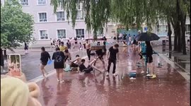 Students play in rain after storm in China