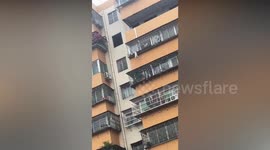 Child hanging from building by head rescued at last minute