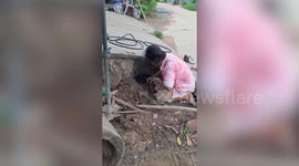 Grandmother digs through sewage pipe to save stuck puppy