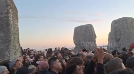 Hundreds gather waiting for the sun to rise at the summer solstice celebrations at stone henge 2024.