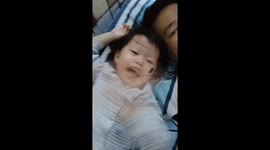 Funny video of a toddler scared of fake cockroach on her face