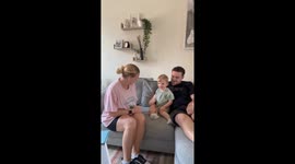 Parents involve excited toddler during intimate gender reveal for baby #2