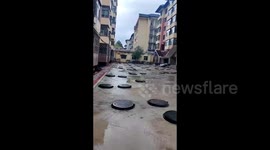 Chinese man shocked as dozens of manhole covers packed in residential community