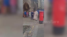 Carole Middleton and Sarah Ferguson embrace outside Tom Kingston's memorial