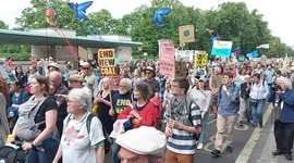 Protestors march past Green Park, London, on the UK's biggest ever march for nature & climate