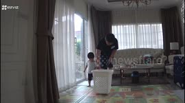 Toddler tumbles over while playing in laundry basket