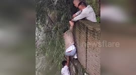 China: Dramatic Rescue in Guizhou as Man Clings to Cliffside in Rushing River