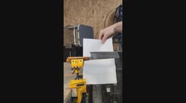 Testing the sharpness of blade by pushing a thin paper through the edge of a handmade kitchen knife.