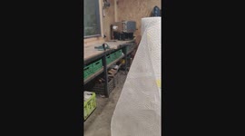 Testing the sharpness of a blade by cutting a thin paper towel with a handmade kitchen knife.