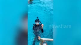 Woman conquers her fear by swimming with over 20 sharks