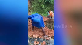 Nepal residents repair roads damaged by landslides as storms kill at least 20
