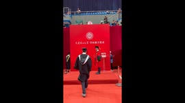 Champagne toast between graduate and professor at degree ceremony in China