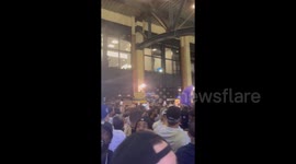 US: Fan In Grimace Costume Chugs Beer During Rain Delay At Citi Field, New York