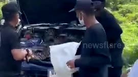 Police drag enormous 13ft-long python out of car engine