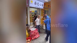 Furious market stall owner hits policeman with SHOVEL in China