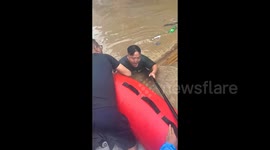 Rescuers save man drowning in deep floodwater in southwestern China