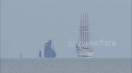 Earth's curvature makes Thames barge appear to be under water off Kent, UK