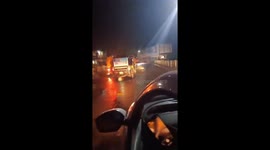 Massive crocodile ambles along road during rain in India
