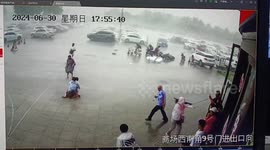 CCTV footage captures brave security guard rescuing mother and daughter toppled by strong winds in China