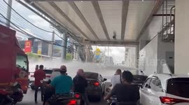 Broken fire hydrant blocks traffic with powerful jet of water