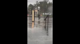 Wind blows away umbrella during rain in Talca, Chile