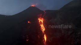 Etna Volcano Erupts: Lava waterfall and strombolian activity from Voragine Crater