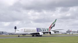 Emirates A380 Wimbledon tournament special tail livery arrives and departs Manchester airport.